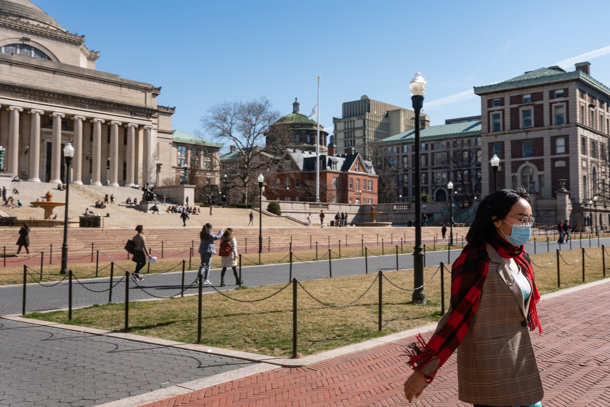 A woman wearing a protective mask walks on the Columbia University campus on March 9 2020.