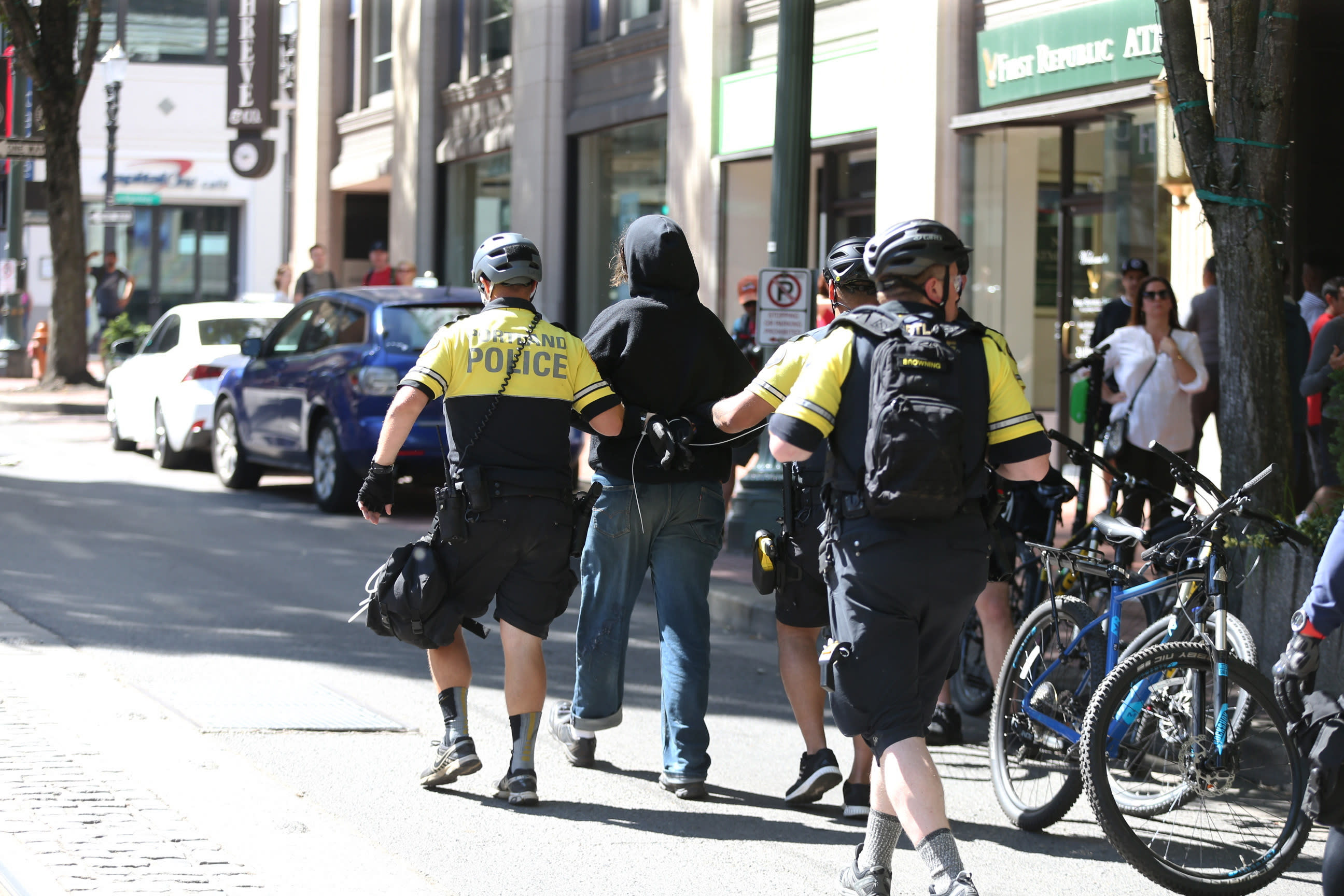 A protestor is taken into custody by police as demonstrators from at least three groups, including members of the so-called Proud Boys and anti-fascist groups, that had planned rallies or demonstrations at different sites in the city gathered, Saturday, June 29, 2019, in Portland, Ore. Competing demonstrations spilled into the streets of downtown Portland, with fights breaking out in places as marchers clashed. (Dave Killen/The Oregonian via AP)